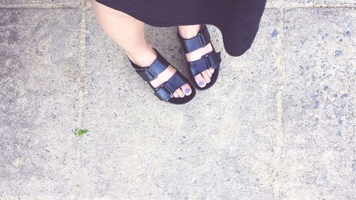 Low section of woman standing on ground