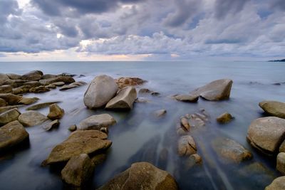 Rocks on beach against sky