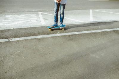 Low section of man skateboarding at park