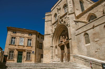 Building and front facade of church at the city center of avignon, in the french provence.