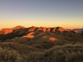 Scenic view of mount pulag against sky during sunset