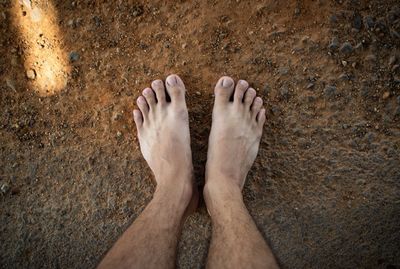 Low section of man standing on floor