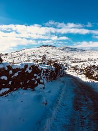 Snow covered landscape against sky