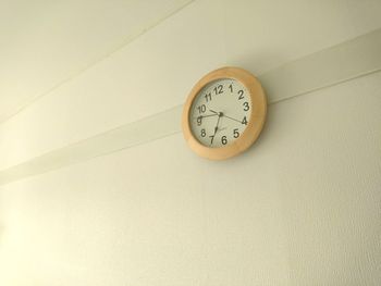 Low angle view of clock on wall