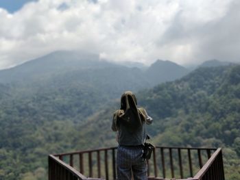 Rear view of woman looking at beautiful mountain