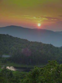 Scenic view of mountains against sky at sunset