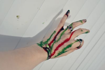 High angle view of woman hand on tiled floor