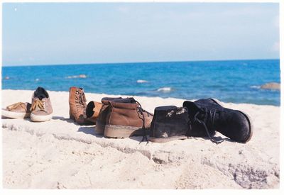 Shoes and boots on shore on sunny day