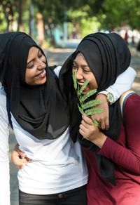 Close-up of happy friends wearing hijab