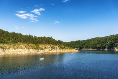 Scenic view of lake against blue sky