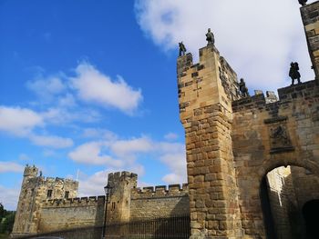 Low angle view of historic building against cloudy sky