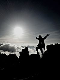 Silhouette of woman against sky