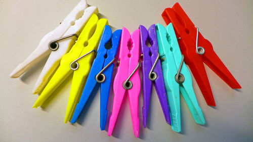 Close-up of multi colored clothespins on table