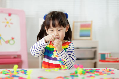 Portrait of cute girl looking at table