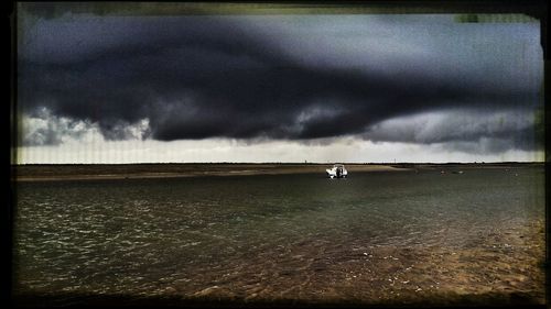 Scenic view of sea against cloudy sky