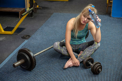 Side view of woman exercising in gym