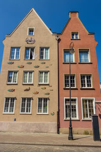 Low angle view of building against blue sky