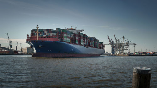 Commercial dock by sea against sky