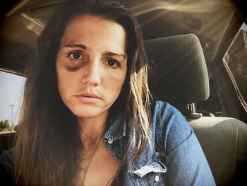 Portrait of woman suffering from violence in car