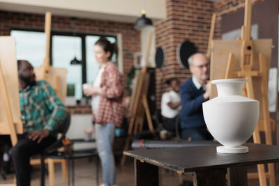 Defocused image of artists working in workshop