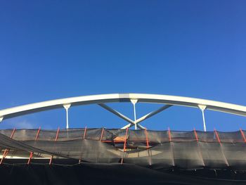 Low angle view of bridge against blue sky