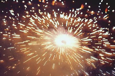 Low angle view of firework display at night