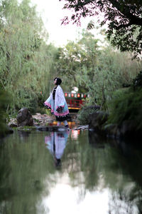 Rear view of man standing in lake