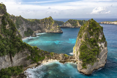 Scenic view of cliff and sea against sky