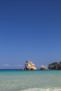 Scenic view of sea against clear blue sky