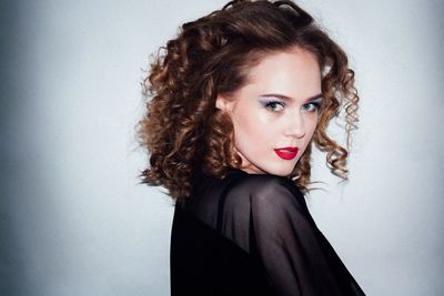 Portrait of beautiful woman with brown curly hair