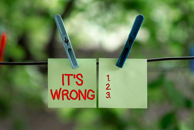 Close-up of clothespins hanging on clothesline