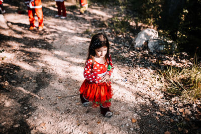 High angle view of girl wearing costume while standing in forest