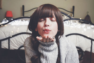 Portrait of young woman looking at home