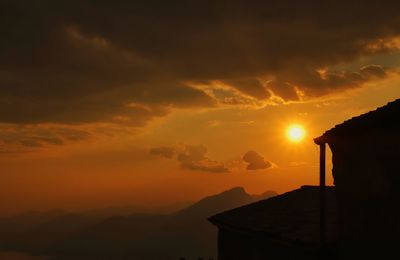 Silhouette buildings against sky during sunset