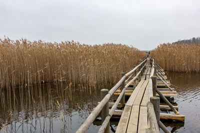 Panoramic shot of land by lake against sky