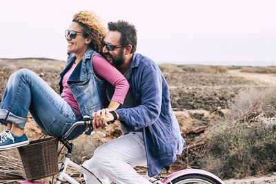 Young couple sitting on land