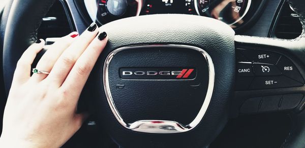 Close-up of hand using laptop in car