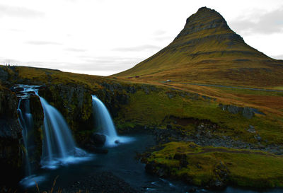 The cone hat mountain is an iconic of iceland with the falls on foreground