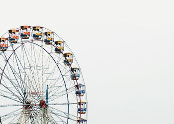 Low angle view of ferris wheel against clear sky