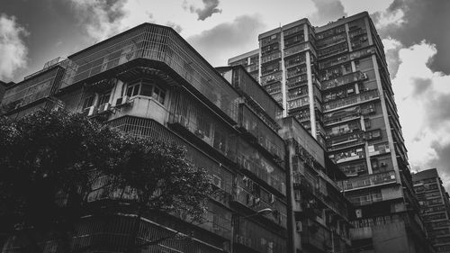 Low angle view of building against cloudy sky