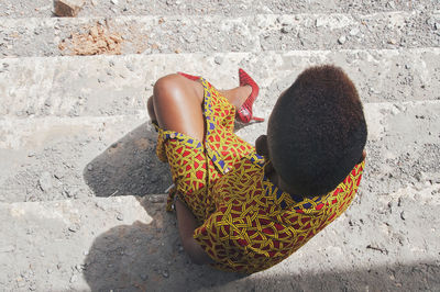 Directly above shot of woman sitting on steps