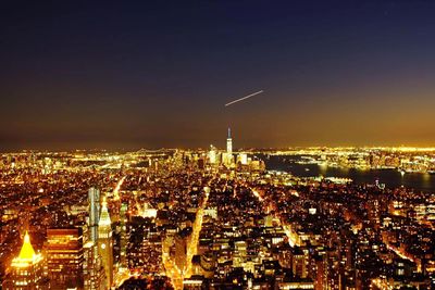 Aerial view of city lit up at night