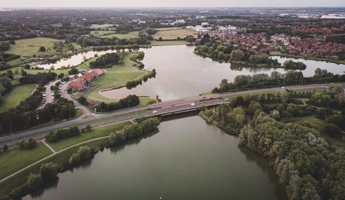 High angle view of river amidst cityscape against sky