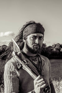 Portrait of man standing against sky