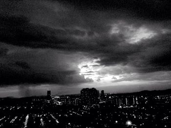 Cityscape against cloudy sky