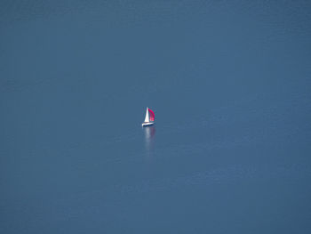 Sailboat on sea against blue sky