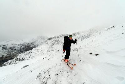 Tourists on snow covered landscape