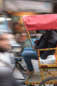 Low section of woman traveling in pedicab