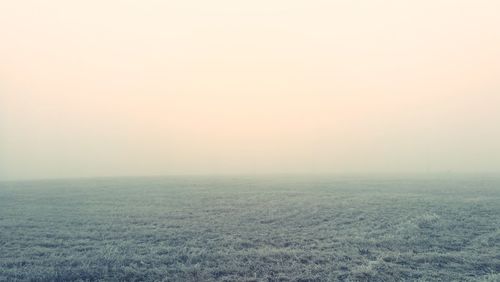 Scenic view of field against sky during winter