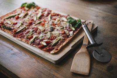 High angle view of pizza on cutting board
